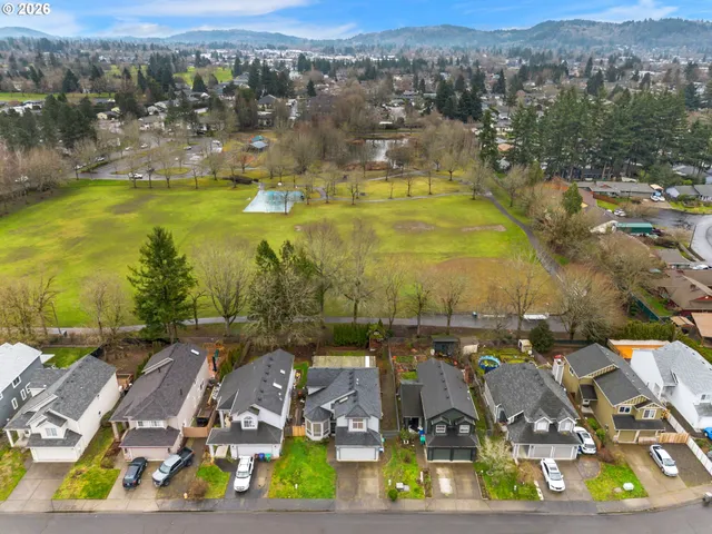 an aerial view of residential houses with outdoor space