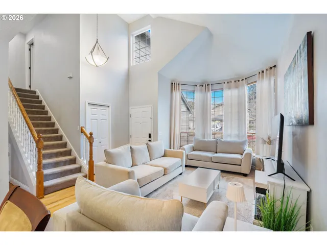 a living room with furniture and a large window