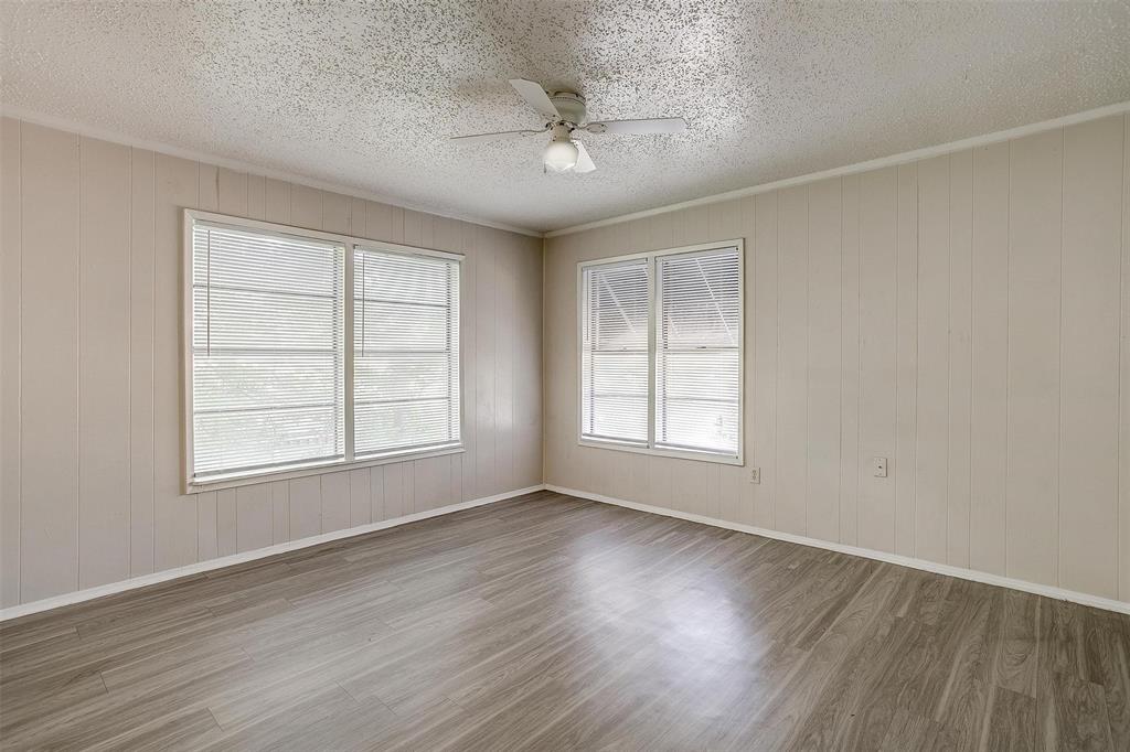 1411 6th Avenue, Unit 2 Fort Worth, TX 76104 - Photo 12 of 21 an empty room with wooden floor and windows