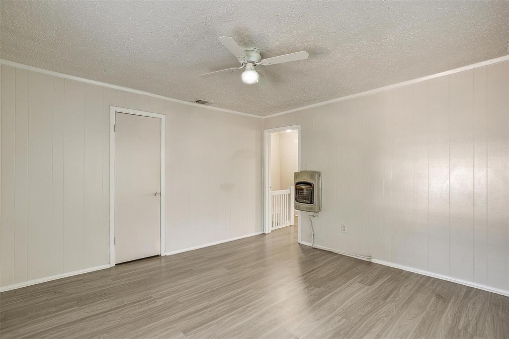 1411 6th Avenue, Unit 2 Fort Worth, TX 76104 - Photo 13 of 21 an empty room with wooden floor and ceiling fan