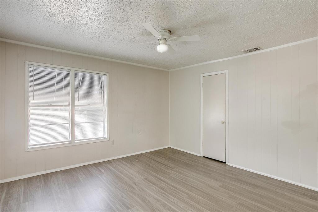 1411 6th Avenue, Unit 2 Fort Worth, TX 76104 - Photo 14 of 21 wooden floor in an empty room with a window