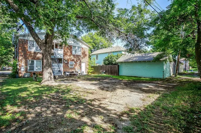 a view of a house with a tree beside it