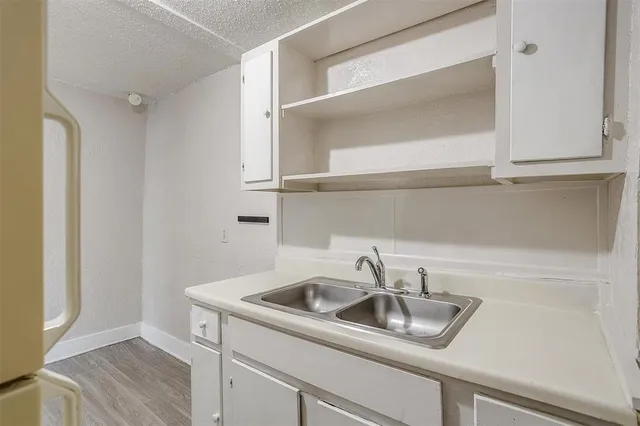 a kitchen with a sink and cabinets