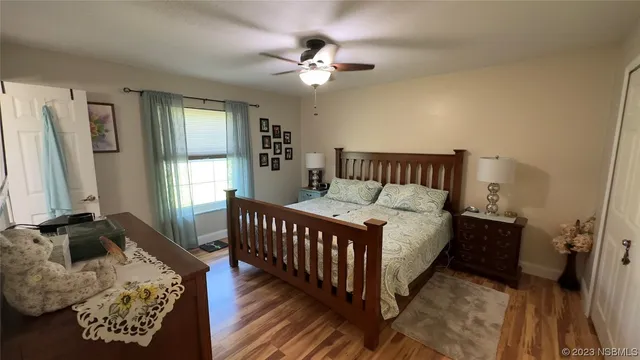 a bed sitting in a bedroom next to a window