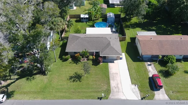 an aerial view of a house with yard swimming pool and outdoor seating