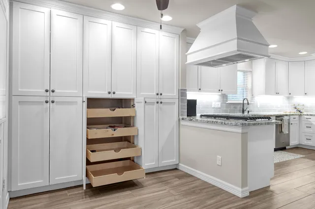 a kitchen with refrigerator and cabinets