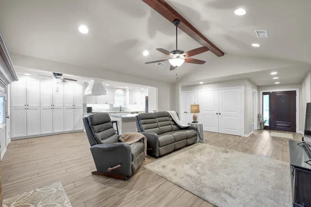 a living room with furniture and a chandelier