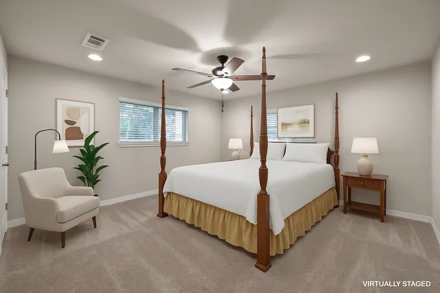 a spacious bedroom with a bed and a chandelier
