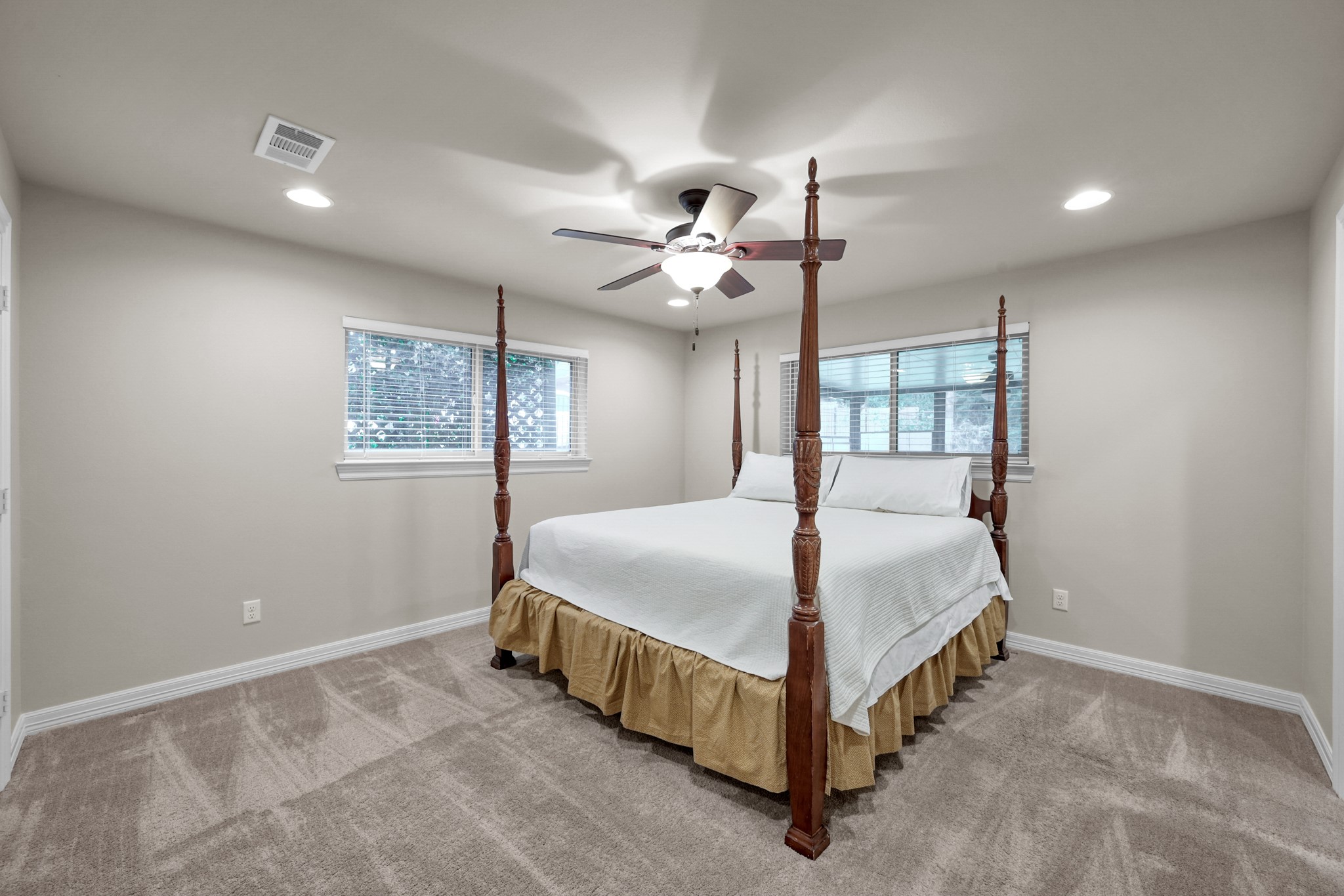 19003 Whitewood Drive Spring, TX 77373 - Photo 18 of 48 a bedroom with a bed and a chandelier