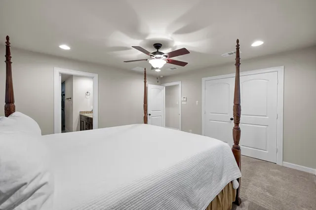 a bedroom with a bed and a ceiling fan