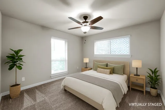 a bedroom with a large bed and a window