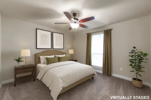 a bedroom with a large bed and a potted plant