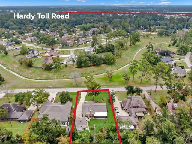 an aerial view of a house with a yard