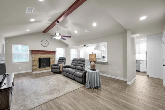 a living room with furniture and a fireplace
