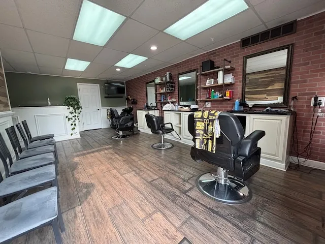 a living room with furniture flat screen tv and wooden floor