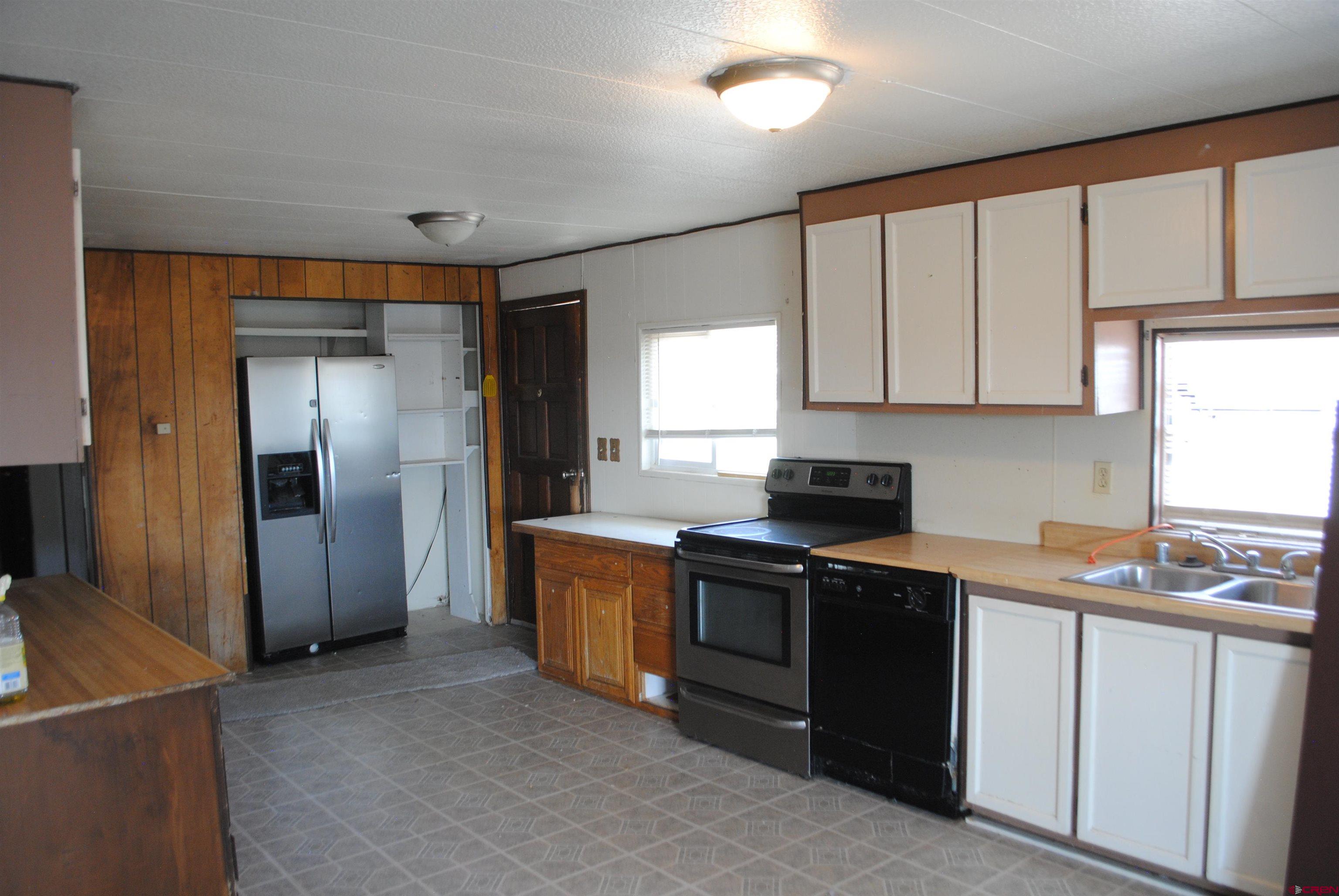 160 Reeder Mesa Road Whitewater, CO 81527 - Photo 5 of 22 a kitchen with stainless steel appliances granite countertop a stove a sink and a refrigerator