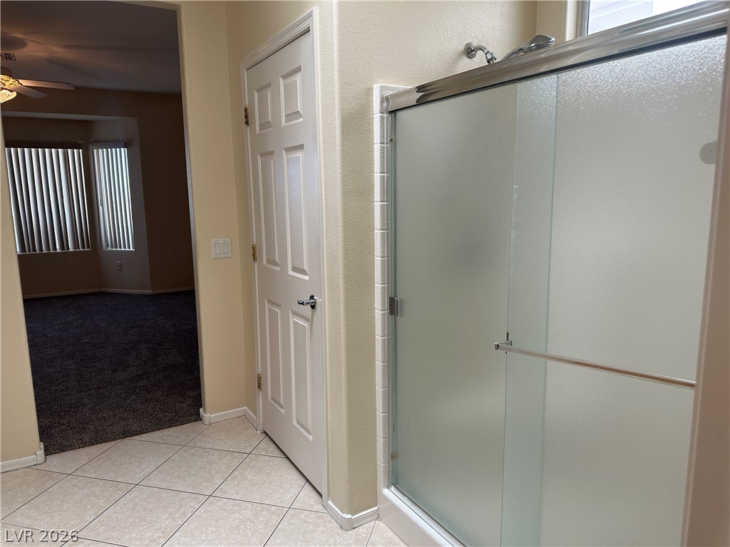 3034 Canal Walk Road Henderson, NV 89052 - Photo 12 of 24 This clean bathroom showcases a modern shower and easy access to an adjoining room.