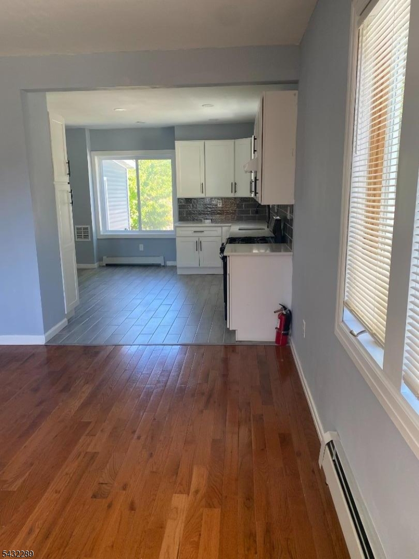 17 Walnut Terrace Bloomfield, NJ 07003 - Photo 11 of 18 an empty room with wooden floor and windows