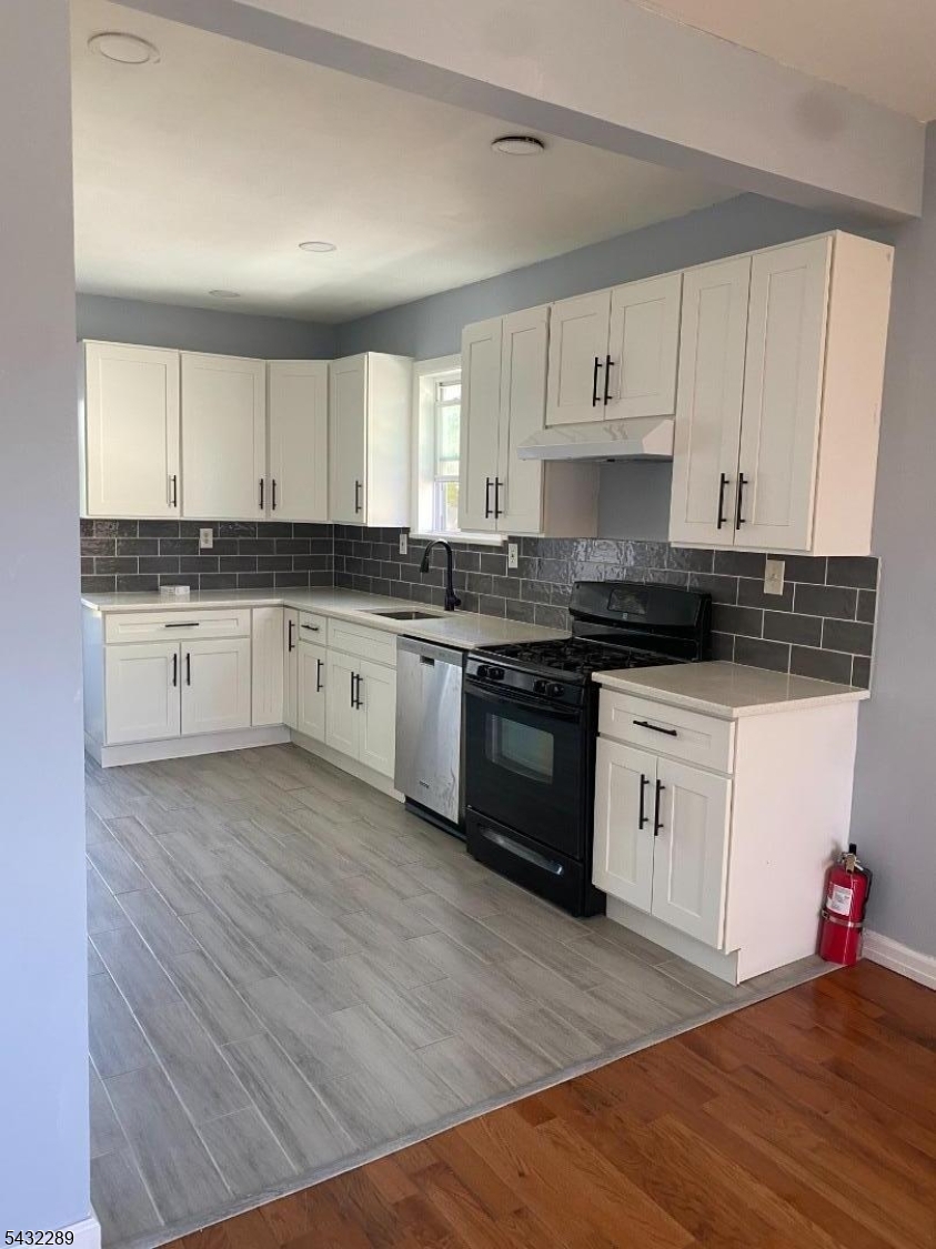 17 Walnut Terrace Bloomfield, NJ 07003 - Photo 12 of 18 a kitchen with granite countertop white cabinets and white appliances