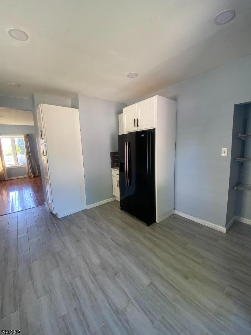 17 Walnut Terrace Bloomfield, NJ 07003 - Photo 13 of 18 an empty room with wooden floor and entrance