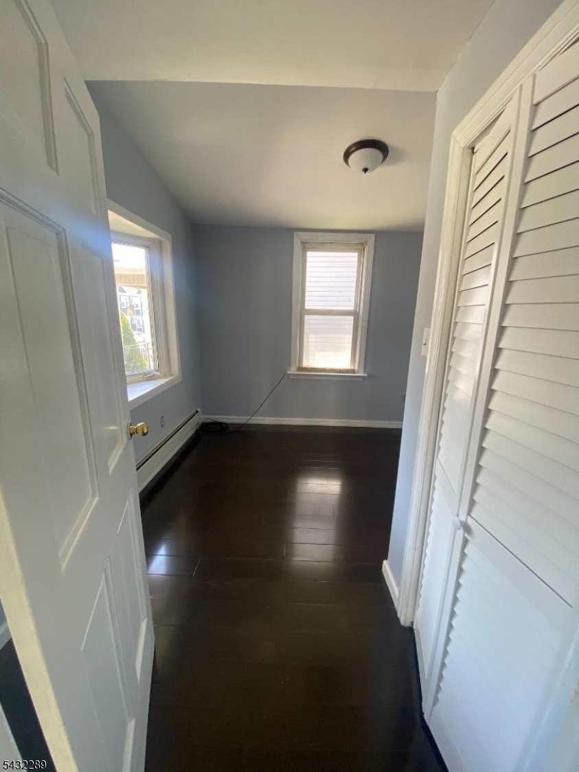 17 Walnut Terrace Bloomfield, NJ 07003 - Photo 6 of 18 wooden floor in an empty room with a window