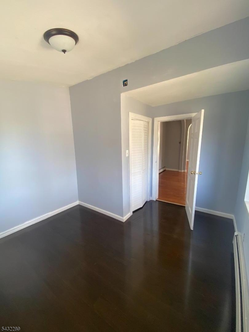 17 Walnut Terrace Bloomfield, NJ 07003 - Photo 7 of 18 a view of an empty room with wooden floor and a window