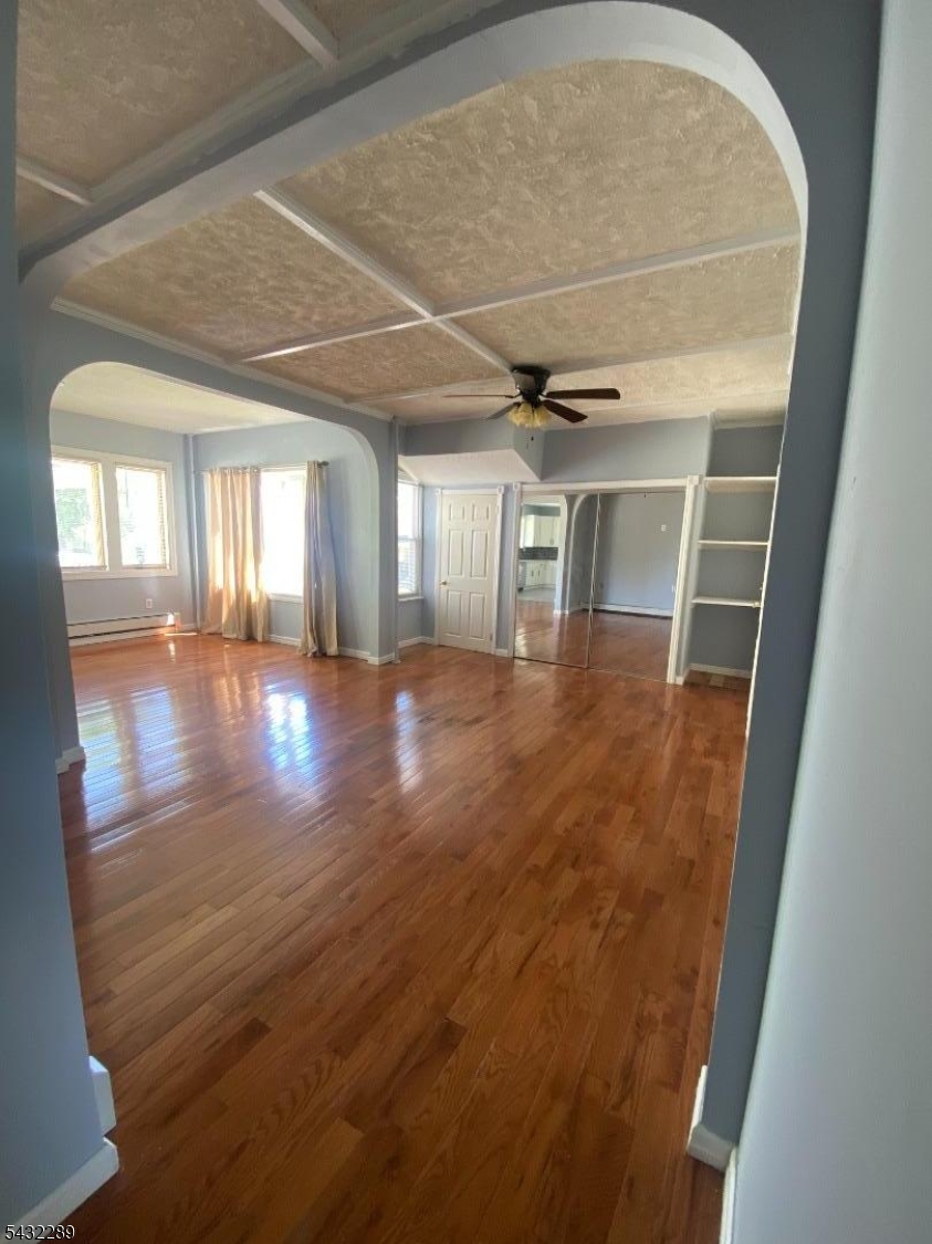 17 Walnut Terrace Bloomfield, NJ 07003 - Photo 8 of 18 en empty room with wooden floor and windows