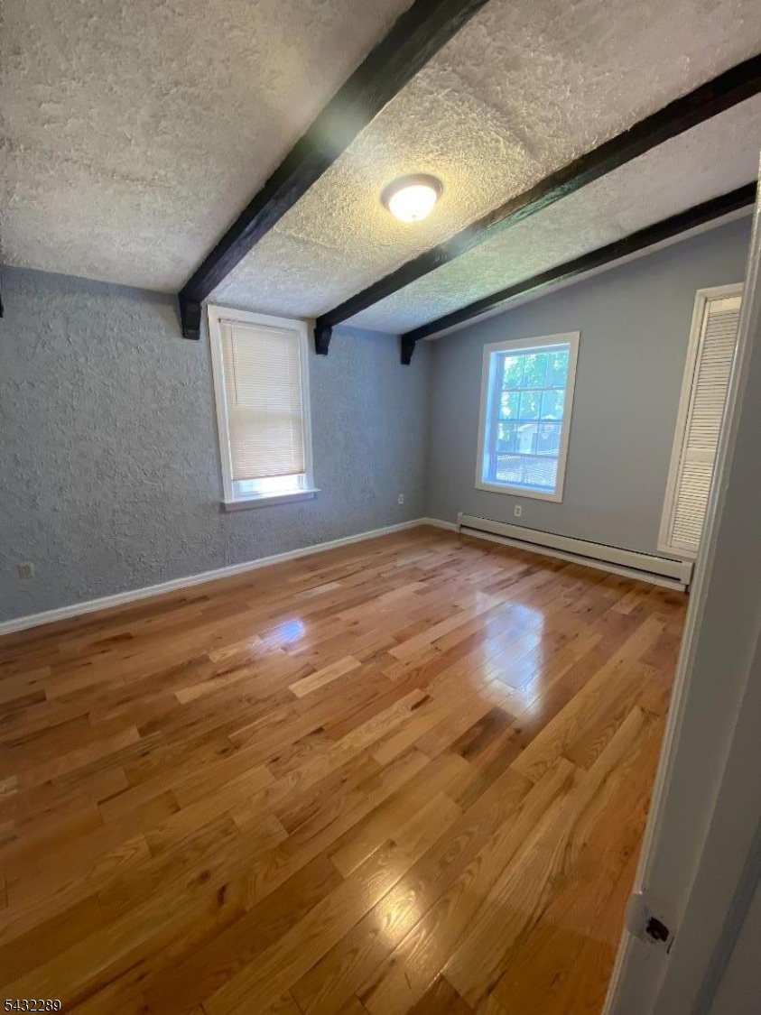 17 Walnut Terrace Bloomfield, NJ 07003 - Photo 10 of 18 a view of empty room with window and fireplace