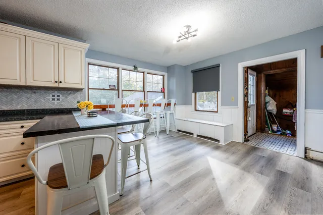 a garage with a stove a table and chairs