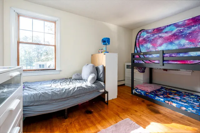 a bedroom with furniture and a window