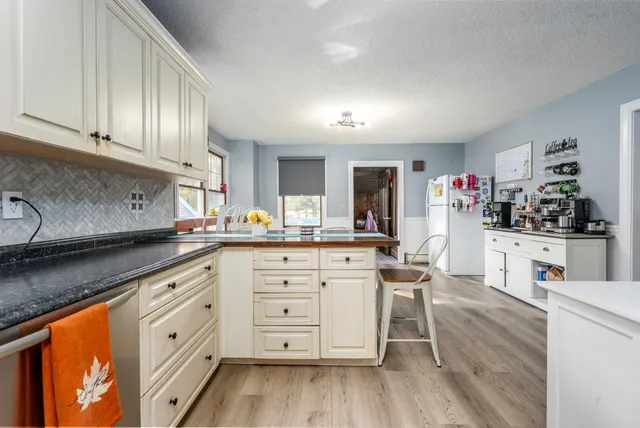 a kitchen with granite countertop cabinets a sink and dishwasher