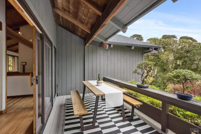 a bedroom with a bed next to a window