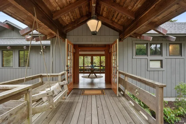 a view of a patio with table and chairs and wooden floor