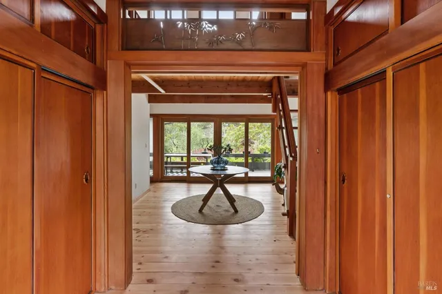 a dining room with wooden floor table and chairs