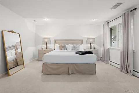 a bedroom with a bed and a mirror