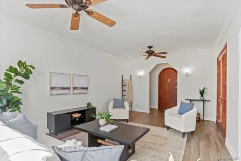 a living room with furniture and wooden floor