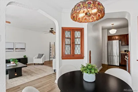 a dining room with furniture and wooden floor