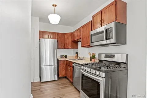 a kitchen with stainless steel appliances granite countertop a stove a refrigerator and a microwave
