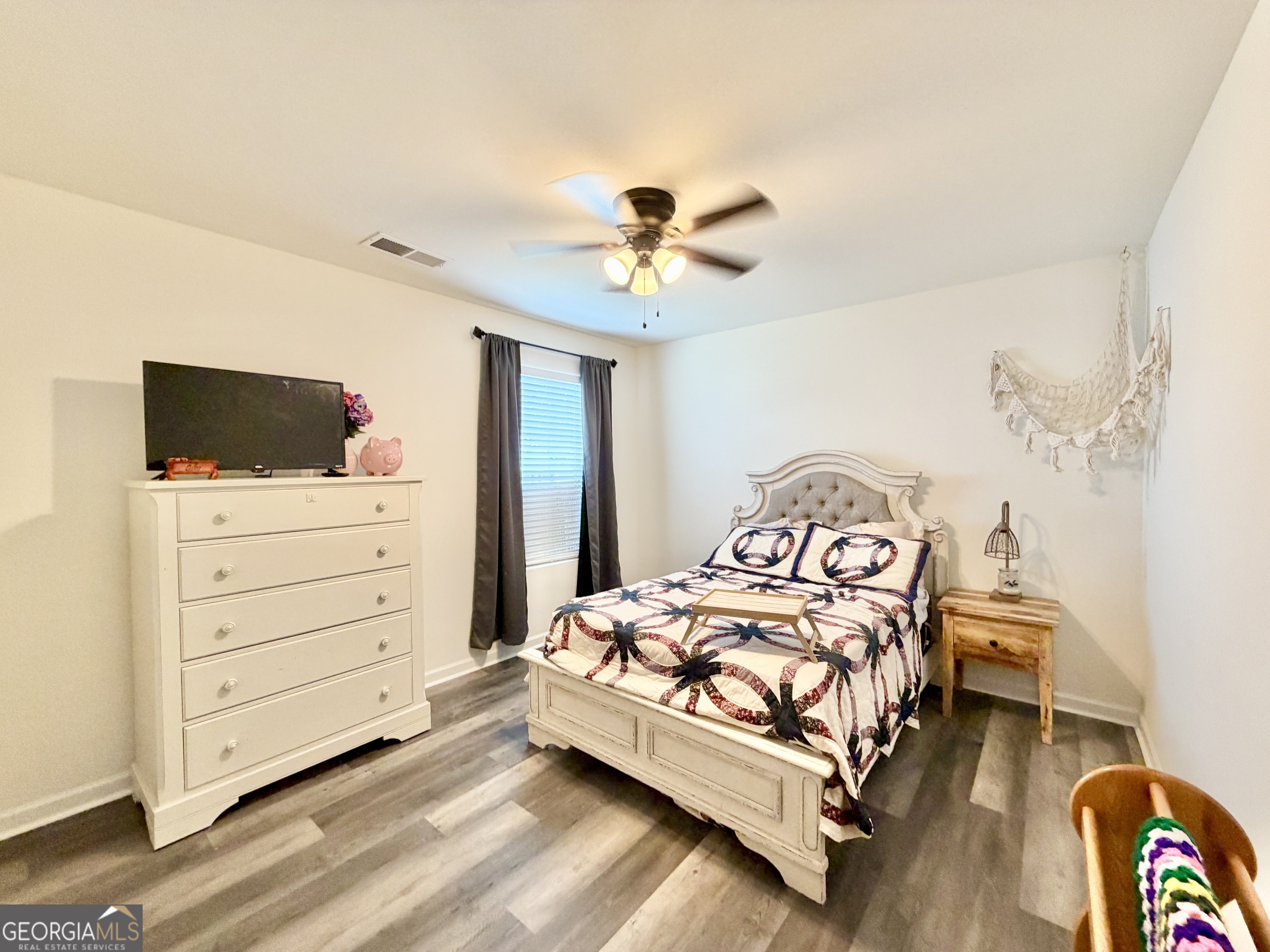 219 Barnyard Way Perry, GA 31069 - Photo 34 of 44 a bedroom with a bed and a flat screen tv
