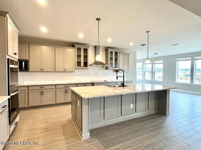 3880 Eagle Rock Road Middleburg, FL 32068 - Photo 6 of 7 a large kitchen with kitchen island a sink stainless steel appliances and cabinets