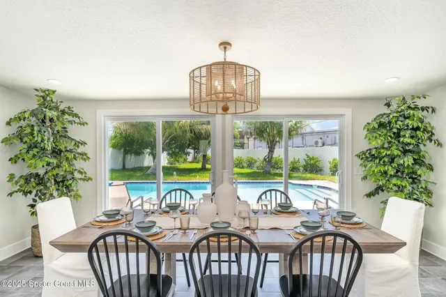 a view of a dining room with furniture window and outside view