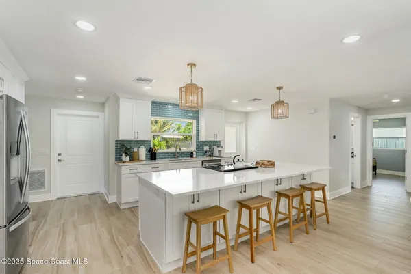 a large kitchen with a table and chairs