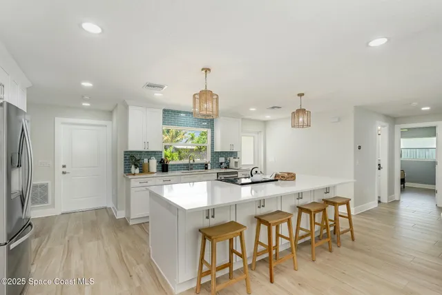 a large kitchen with a table and chairs