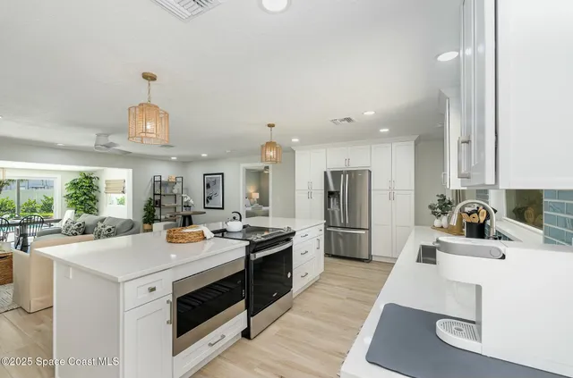 a kitchen with a sink appliances and cabinets
