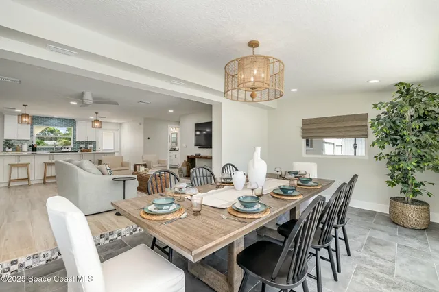 a view of a dining room with furniture wooden floor and chandelier