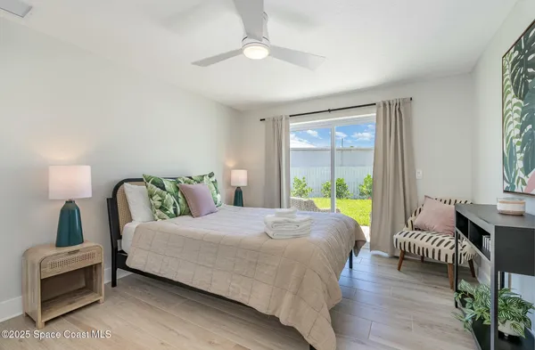 a bedroom with a bed and a large window
