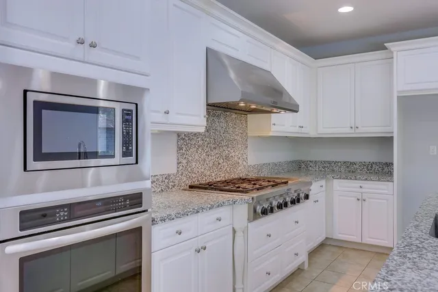 a kitchen with granite countertop a stove and a sink