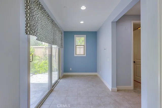 a bathroom with a granite countertop toilet a sink a mirror a window and a shower