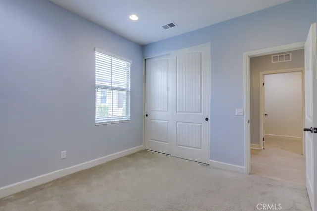 a view of a house with a yard and potted plants