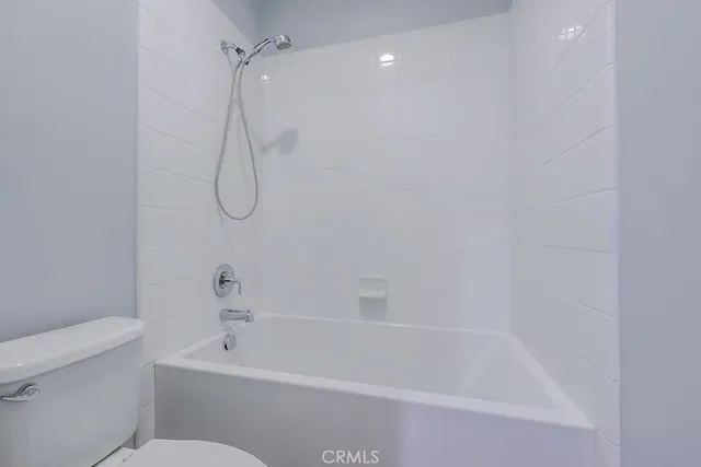 a front view of a house with a yard and palm trees